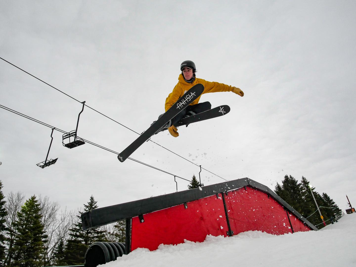 skier going off rail jump
