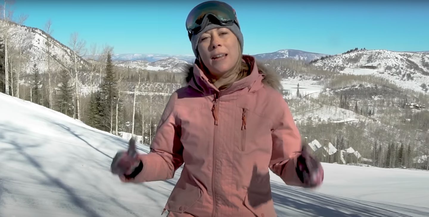 person talking to camera on ski hill