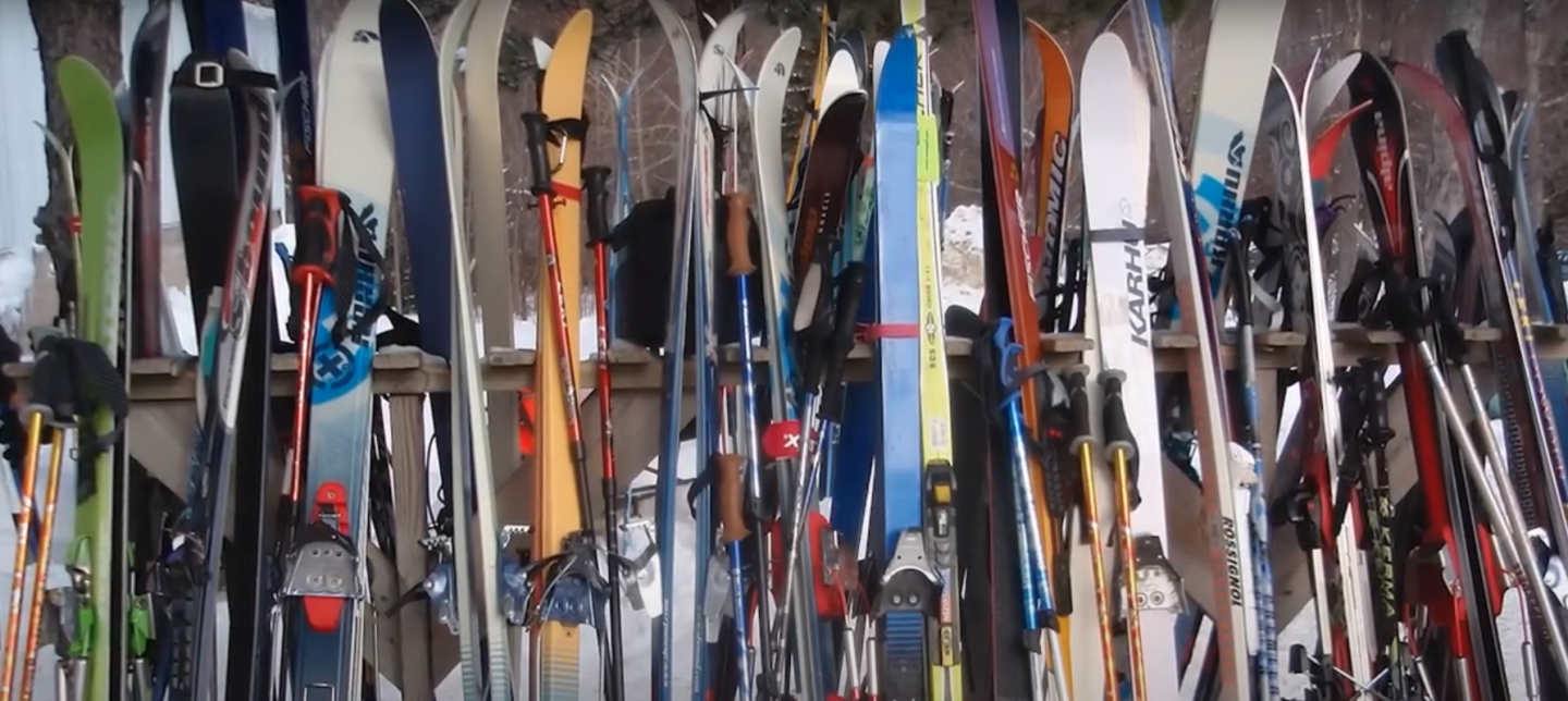 skis sitting up against ski rack