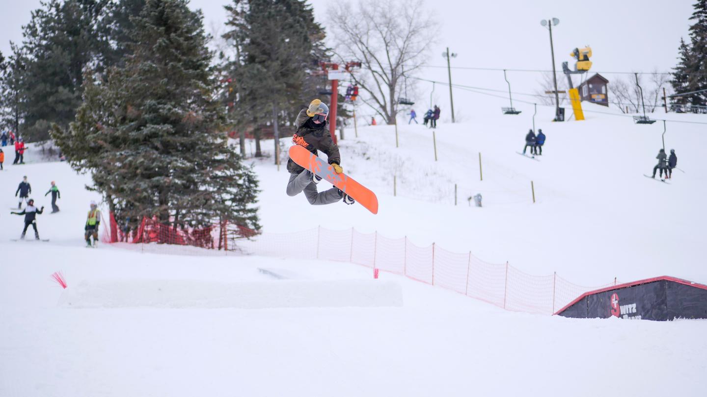 Snowboarder mid air doing trick