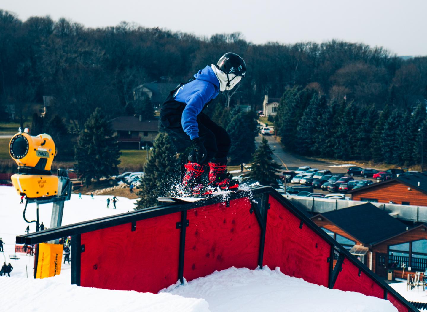 back of snowboarder, going down a rail