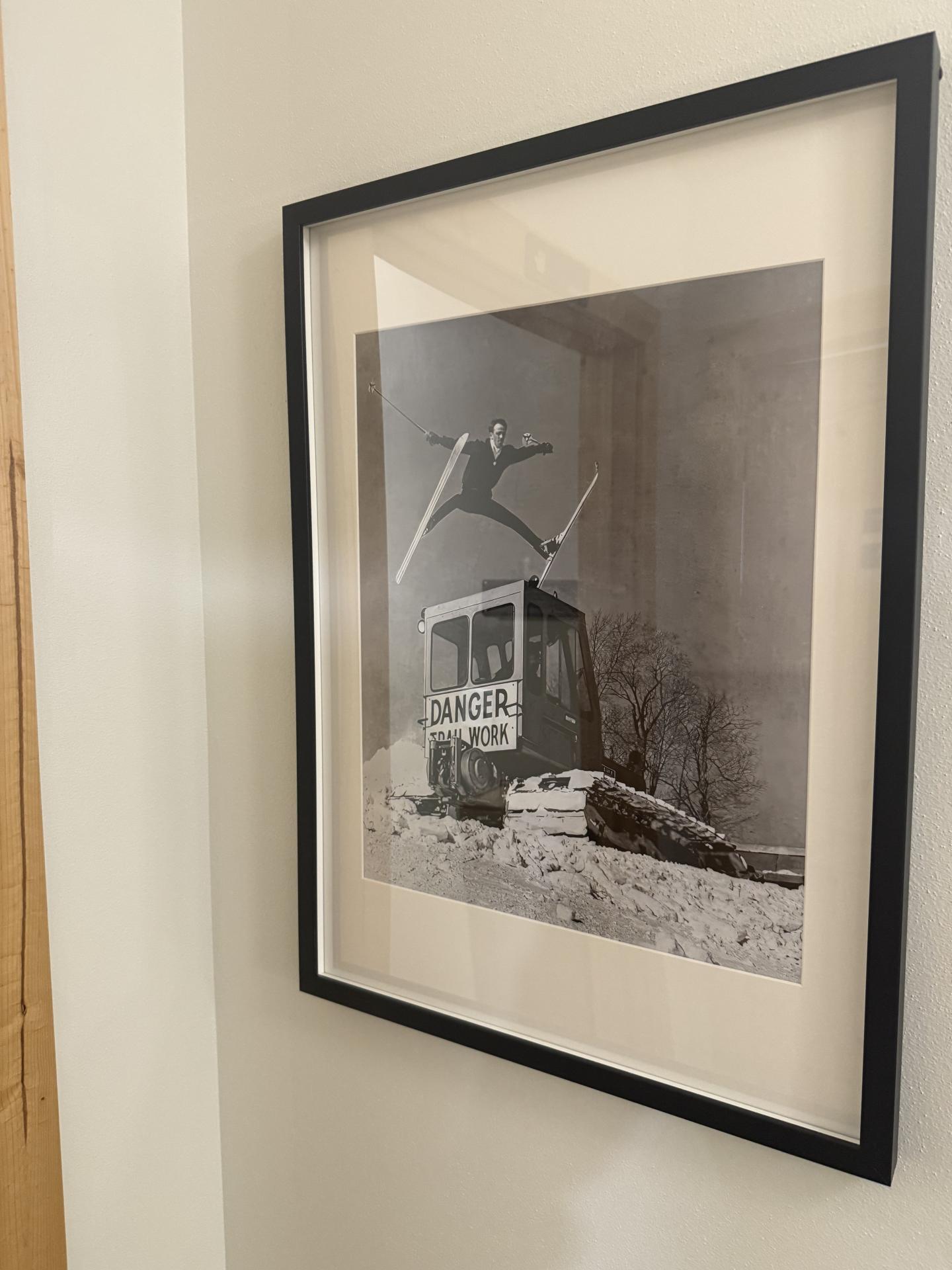 Framed photograph of a person skateboarding over a large box labeled "DANGER," in black and white.