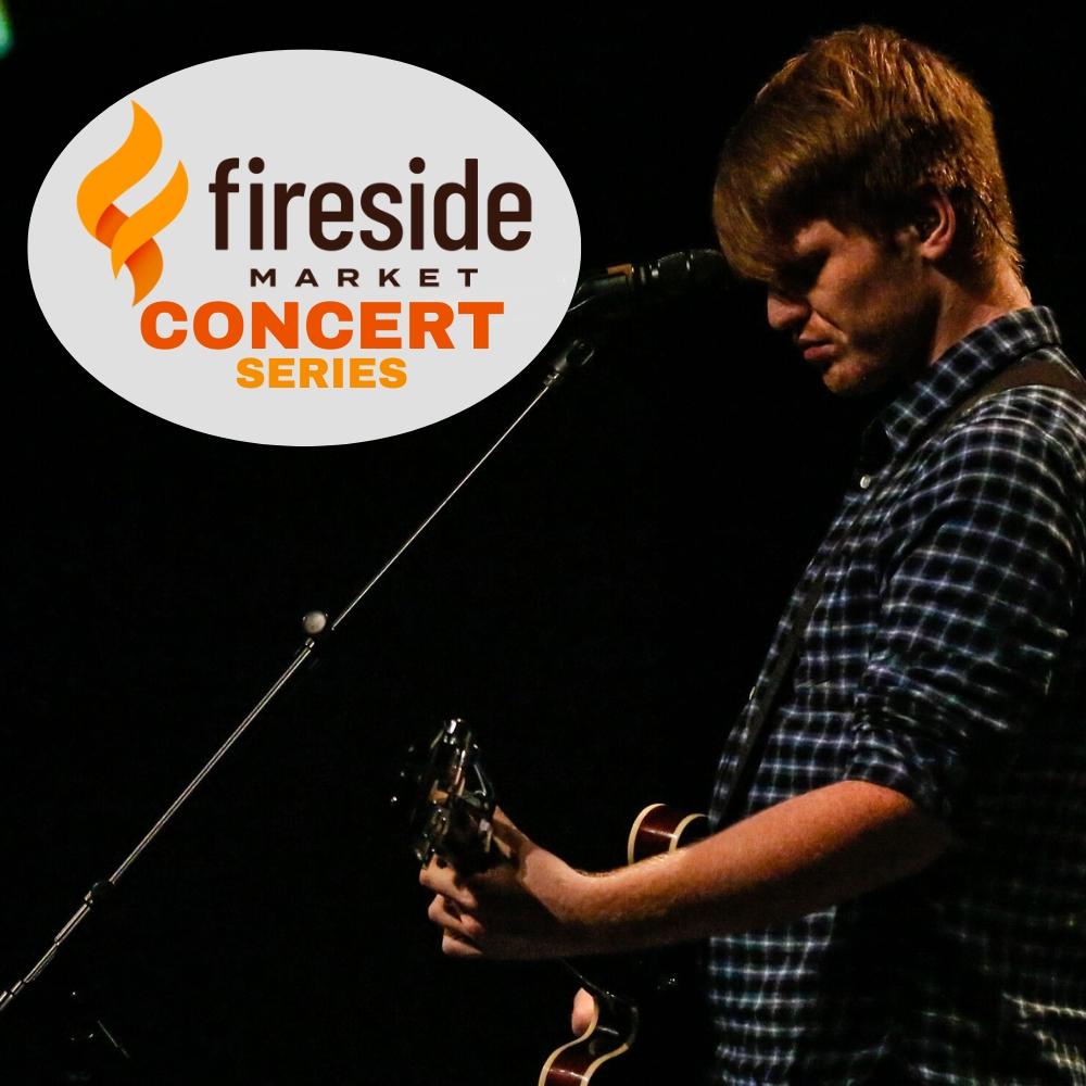 Musician playing guitar on dark stage; "Fireside Market Concert Series" logo.