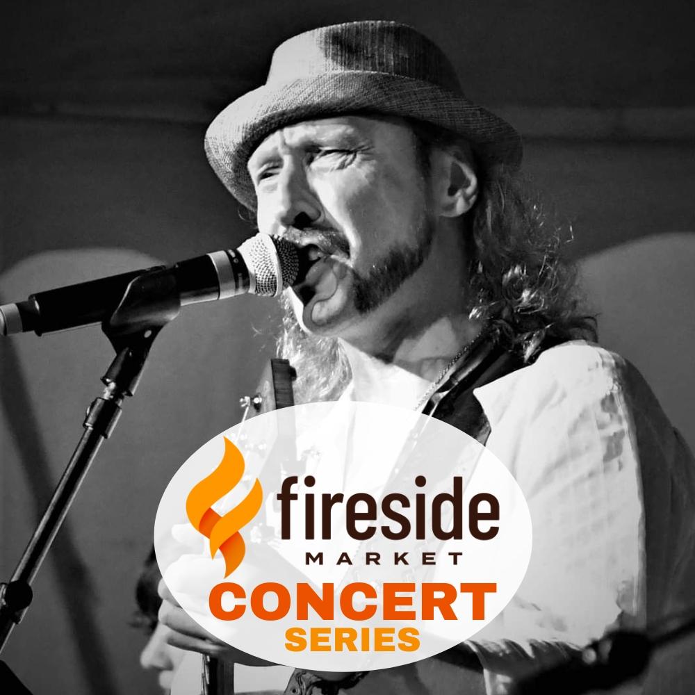 Singer in hat performing at Fireside Market Concert Series.